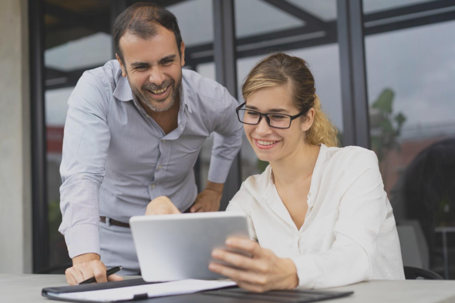 Person reviewing financial reports and making notes on budget analysis